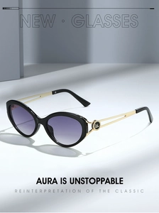 Detail of cat eye sunglasses with gold hollow temples and purple gradient lenses