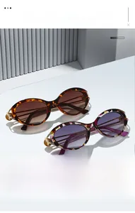 Detailed close-up of leopard print sunglasses featuring elegant metal hinge construction