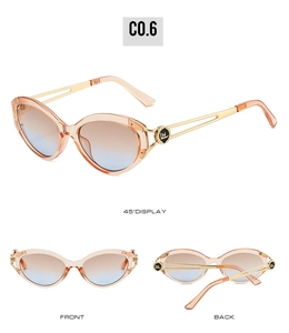 Detail view of cat eye sunglasses with gold hollow metal temples and gradient lenses