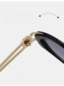 Detail shot of durable golden metal hinges on stylish black cat-eye sunglasses