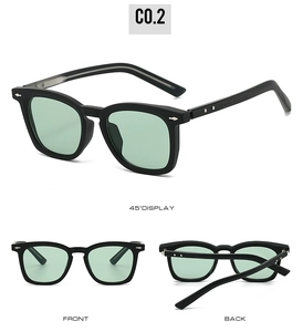 Detailsicht der quadratischen schwarzen Sonnenbrille mit grünen Gläsern und Nieten