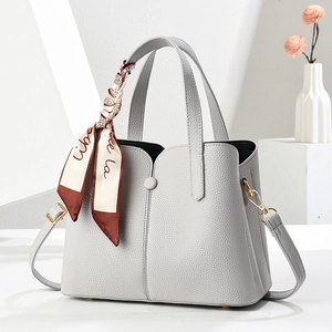 Minimalist light grey lychee textured handbag with silk scarf and crossbody strap