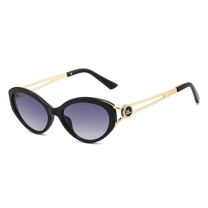 Cat eye sunglasses with purple gradient lenses and hollow gold metal temples