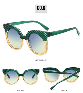 Detail of green textured frame and yellow gradient lenses on trendy sunglasses