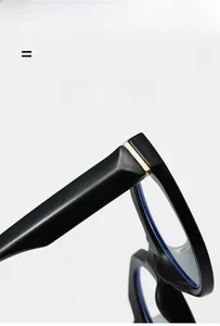 Detail of glossy black frame with golden striped metal hinge and anti-blue light lens