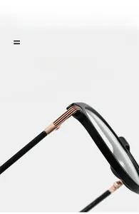 Detail of lightweight black glasses hinge with gold metal joint and signature stripes