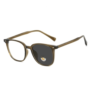 Retro photochromic sunglasses with amber frame showing 2-in-1 clear to dark lens transition