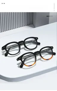 Detailed view of retro round glasses with silver embossed cross patterns on the temple