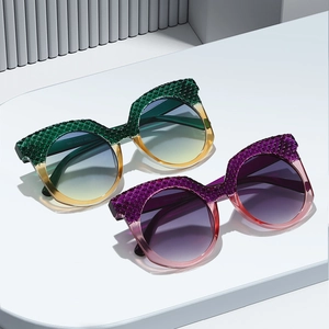 Cat eye oversized sunglasses with grid texture and gradient lenses on a minimalist stand