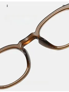 Detail of ergonomic integrated nose pads on amber TR90 round frame eyeglasses