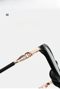 Macro shot of stylish black glasses frame featuring rose gold metal hinges and crystals