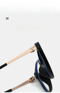 Detailed close-up of shiny black frame hinge with rose gold metal temple and unique logo