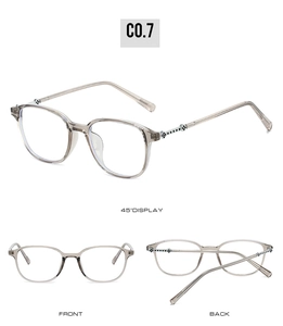 Detail view of transparent grey glasses with floral metal relief on stainless steel temples