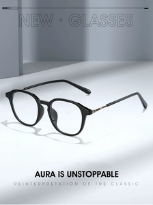 Close-up of black frames with golden hinges and circular logo on eyewear temples
