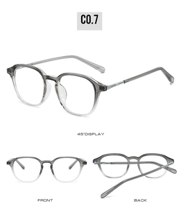 Detail view of stylish round glasses frame with gradient gray finish and metal logo accents