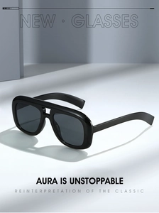 Close-up of black oversized sunglasses with double bridge and thick retro frames