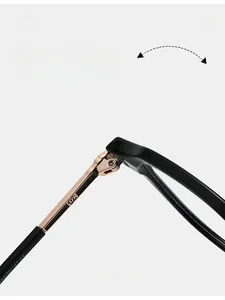 Detailed close-up of premium metal hinge on black eyeglasses with double C logo emblem