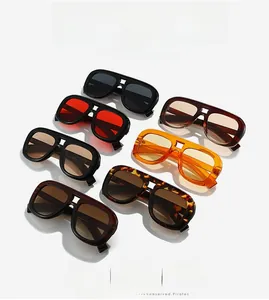 Multiple pairs of oversized retro square sunglasses in various colors on white backdrop