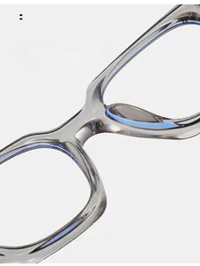 Detail of grey square frame glasses showing integrated bridge for comfortable wear