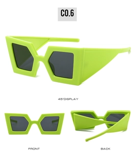 Detail view of bold neon green chunky frames and wide temples of fashionable oversized sunglasses