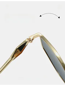 Close-up of durable metal hinges on polygon sunglasses with gold finish and dark lenses