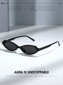 Detail view of stylish black oval sunglasses with sleek frames and premium studio lighting