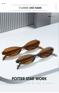 Detail of oval cat-eye sunglasses in transparent tea and grey on a modern stand