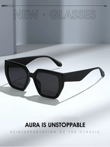 Detail of oversized black square sunglasses with thick glossy frames and dark lenses