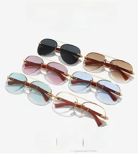 Detail of rimless pilot sunglasses with wooden temples and metal double bridge design
