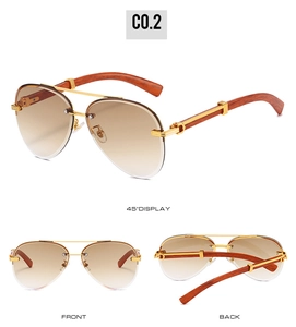 Detail of rimless pilot sunglasses with brown gradient lenses and faux wood temples
