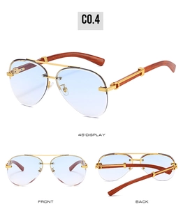 Detail of rimless aviator sunglasses with light blue lenses and wood grain temples