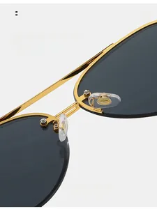 Macro detail of adjustable anti-slip silicone nose pads on gold frame aviator sunglasses