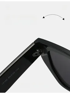 Detailed macro view of durable reinforced metal hinge on oversized black frame sunglasses