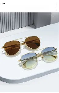 Close-up of classic aviator sunglasses with gold metal frames and gradient lenses
