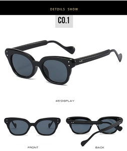 Gros plan de lunettes de soleil œil-de-chat noires rétro avec monture épaisse et rivets