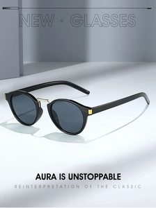 Detail of vintage round sunglasses featuring a golden bridge and sleek black frame