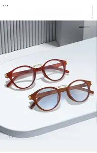 Close-up of retro round eyewear frames in amber brown and wood grain with metal bridge