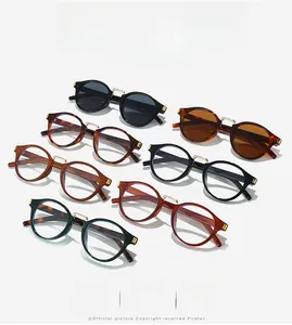 Detail view of retro round frame pilot sunglasses with metal bridge in multiple colors