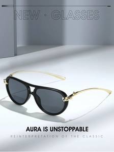 Detail of pilot sunglasses showing golden rope-texture metal temples and black frame