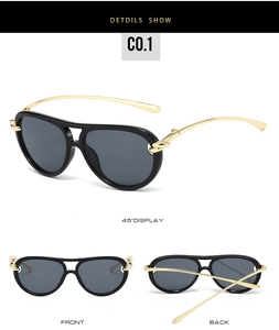 Detail of aviator sunglasses featuring black frames and gold metal knotted temples