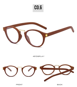 Detail of vintage round metal pilot sunglasses showing walnut wood texture and gold accents