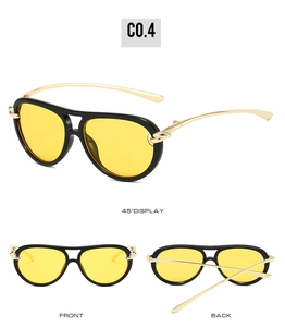 Detail view of aviator sunglasses with gold knot design on black and gold temples