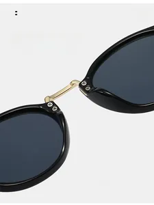 Detail of comfortable resin nose pads on retro pilot sunglasses with gold metal bridge