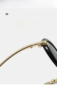 Macro detail of gold knotted hinge and black frame on flexible pilot sunglasses
