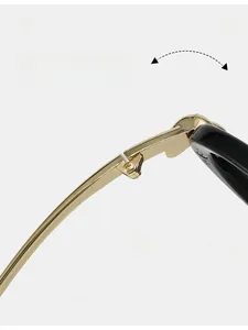 Detail of durable gold metal hinge on black pilot sunglasses with smooth texture