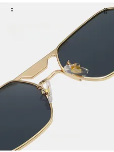Detailed close-up of soft silicone nose pads and golden metal frame of square sunglasses