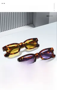 Detail of vintage tortoise square sunglasses with yellow and purple lenses and gold studs
