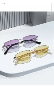 Detail of retro rectangular metal sunglasses with silver and gold frames and gradient lenses