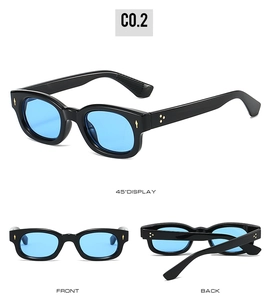 Detailed close-up of retro square sunglasses featuring blue lenses and metal rivet accents