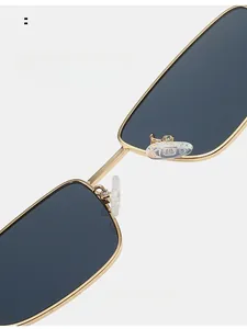 Detailed close-up of adjustable silicone nose pads on gold metal square sunglasses